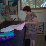 member preparing material for sewing