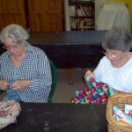 two members sewing separate pieces